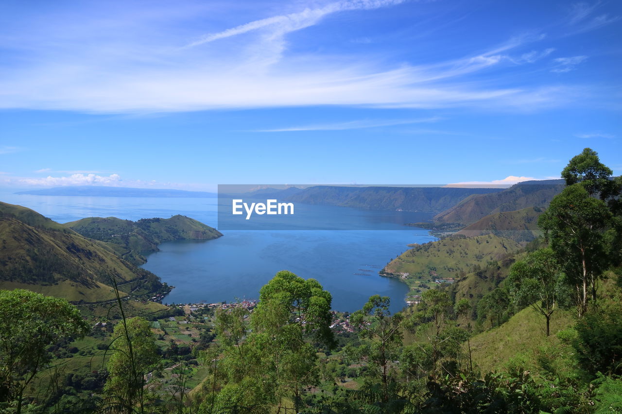 Scenic view of sea and mountains against sky