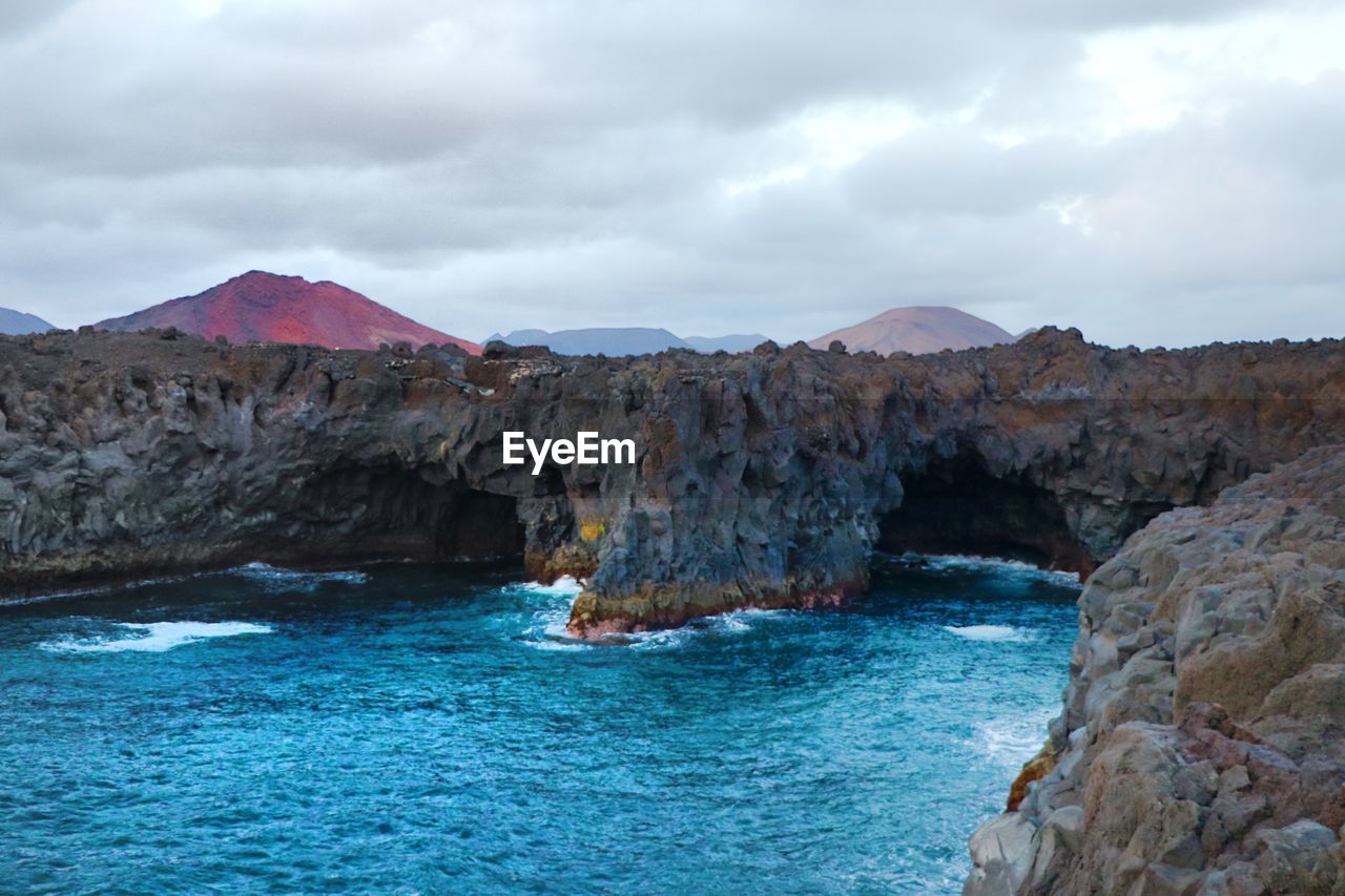 Scenic view of sea and rocks against sky