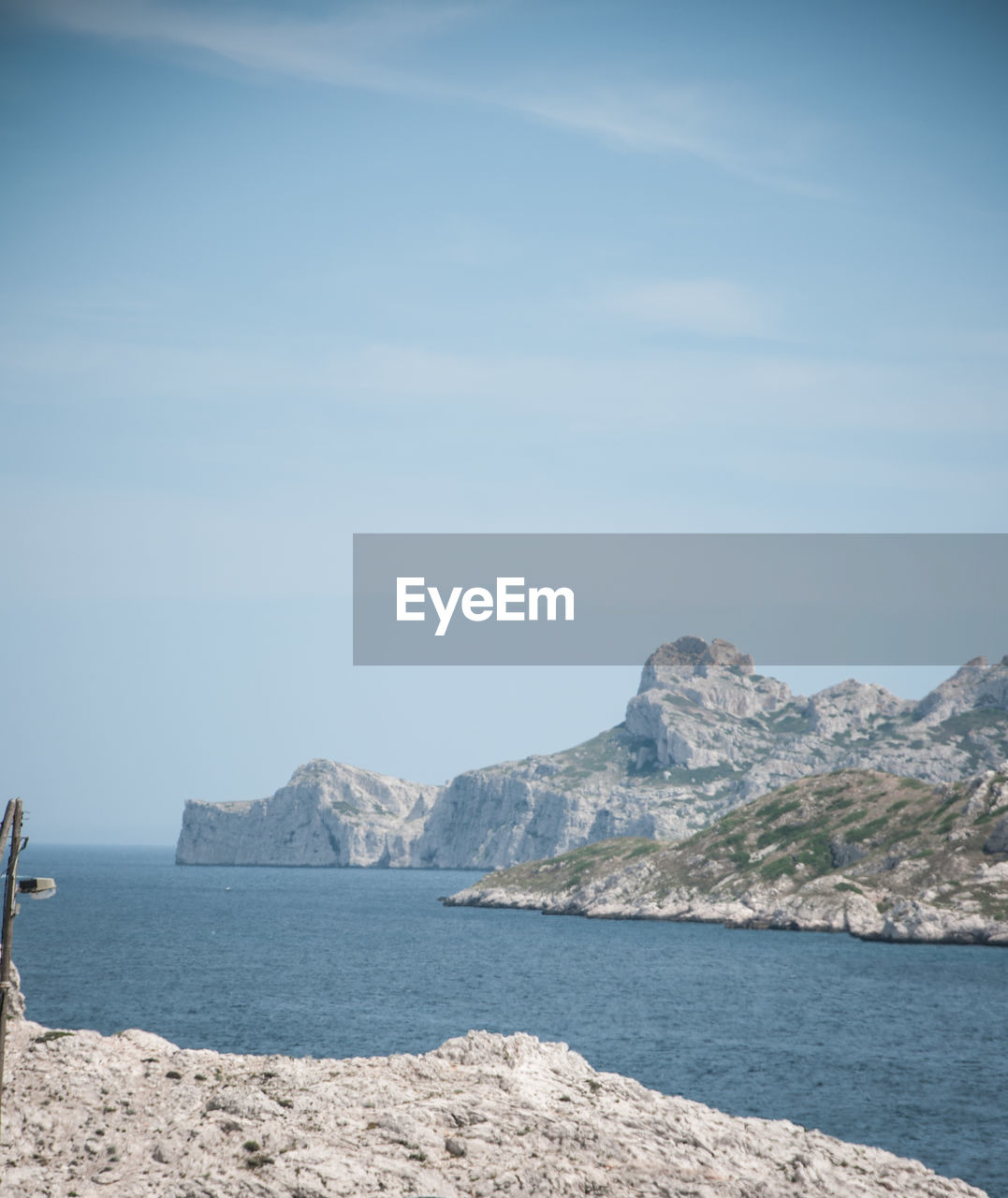 Scenic view of sea and mountains against sky