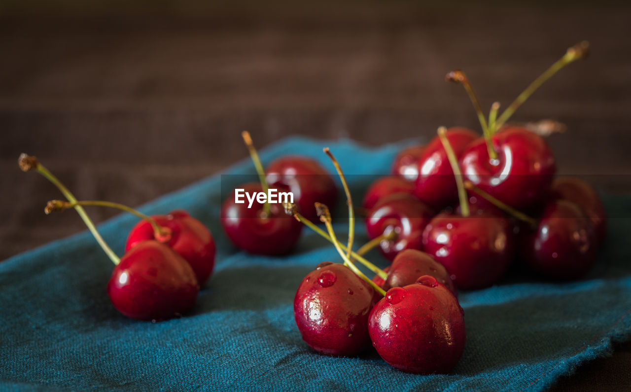 Close-up of red cherry fruits on table