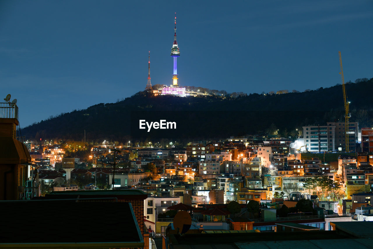 illuminated cityscape against sky at night