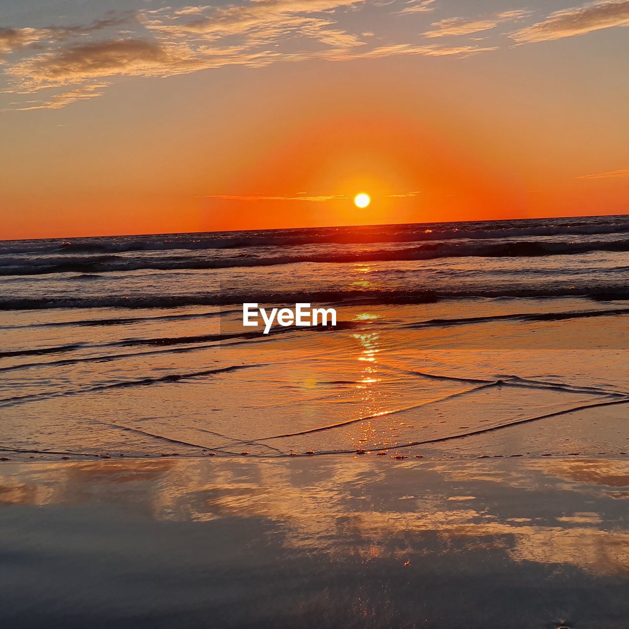 SCENIC VIEW OF SUNSET OVER SEA