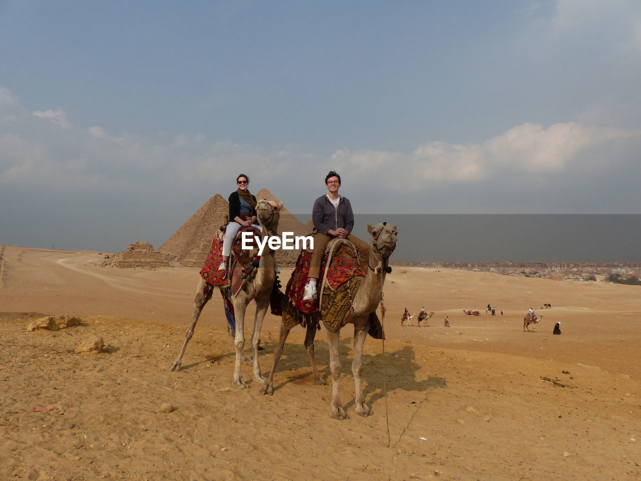 People riding camels in desert