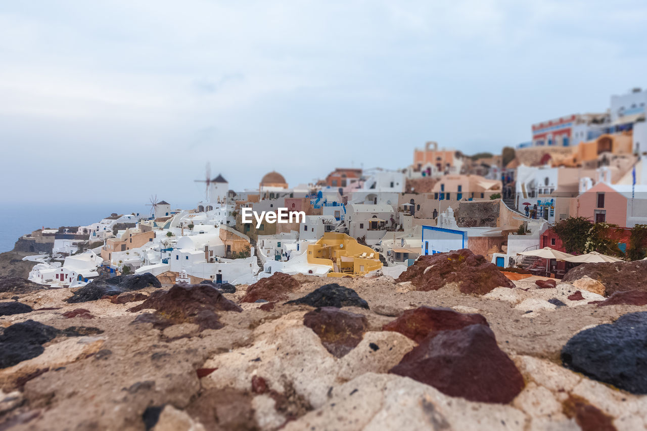 Tilt shift effect of oia village panorama on a rare rainy day, santorini, greece