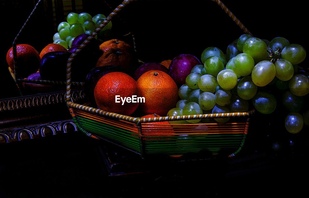Close-up of fruits in basket on table