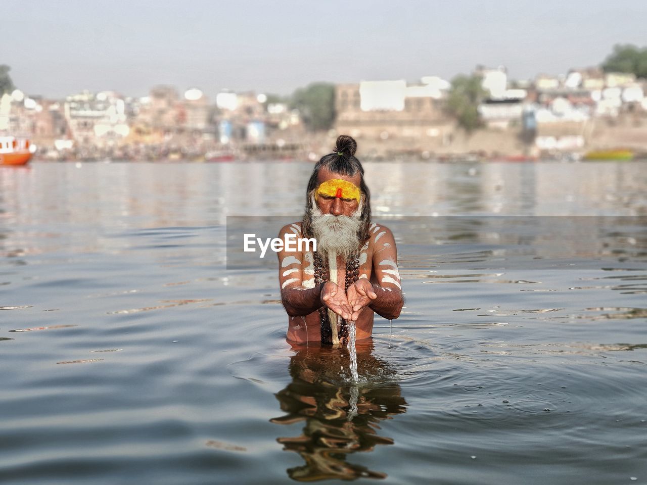 water, one person, architecture, nature, sea, city, day, front view, outdoors, swimming, building exterior, childhood, portrait, built structure, sky, waterfront, fun, men, child, adult, lifestyles, animal, clothing, looking at camera, focus on foreground, building, reflection