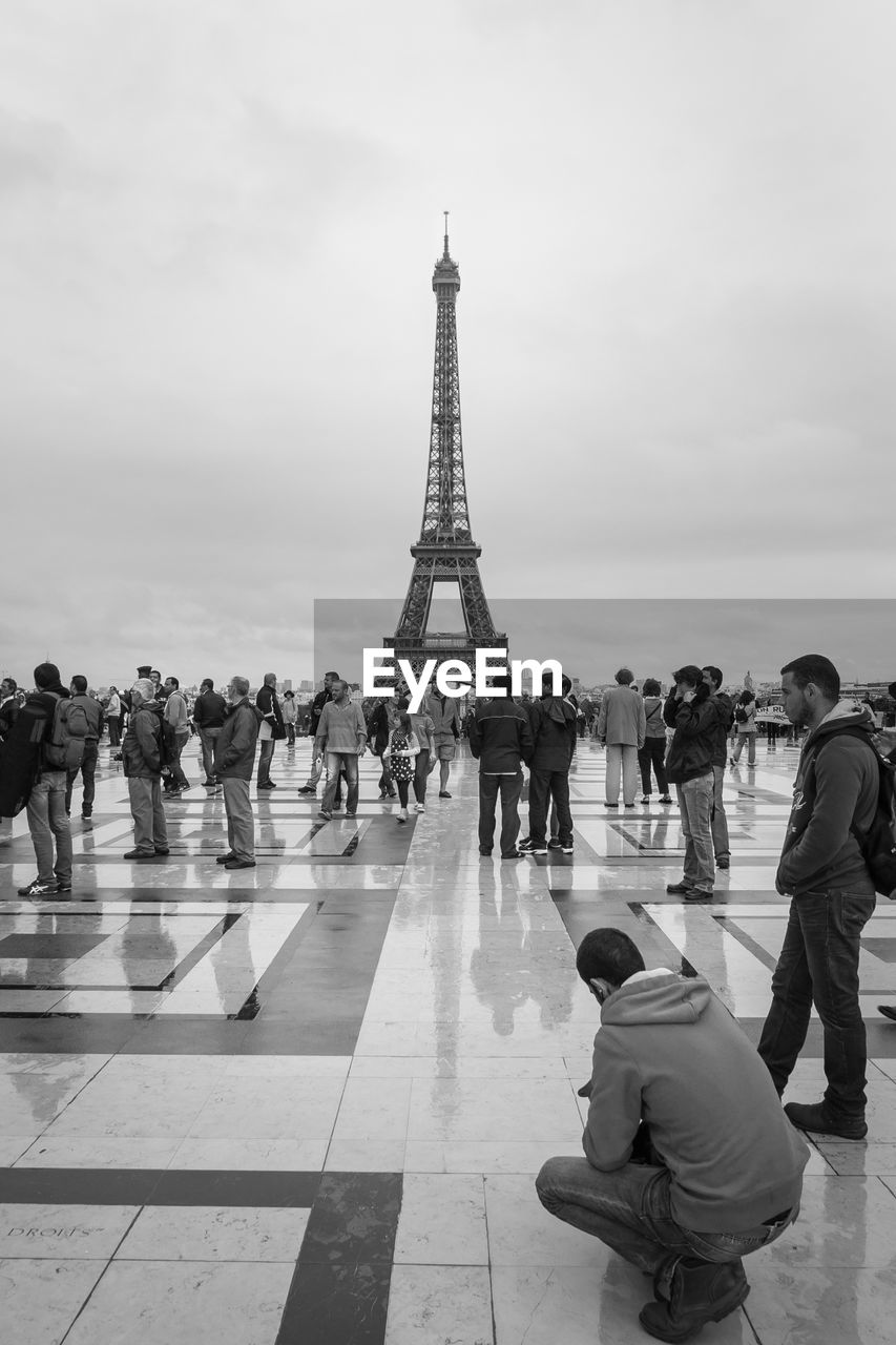 People in front of eiffel tower against sky
