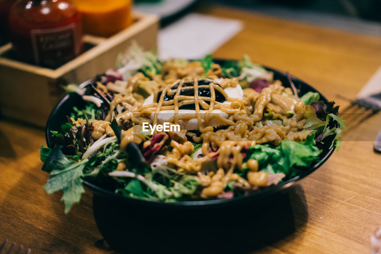 Close-up of salad in bowl on wooden table