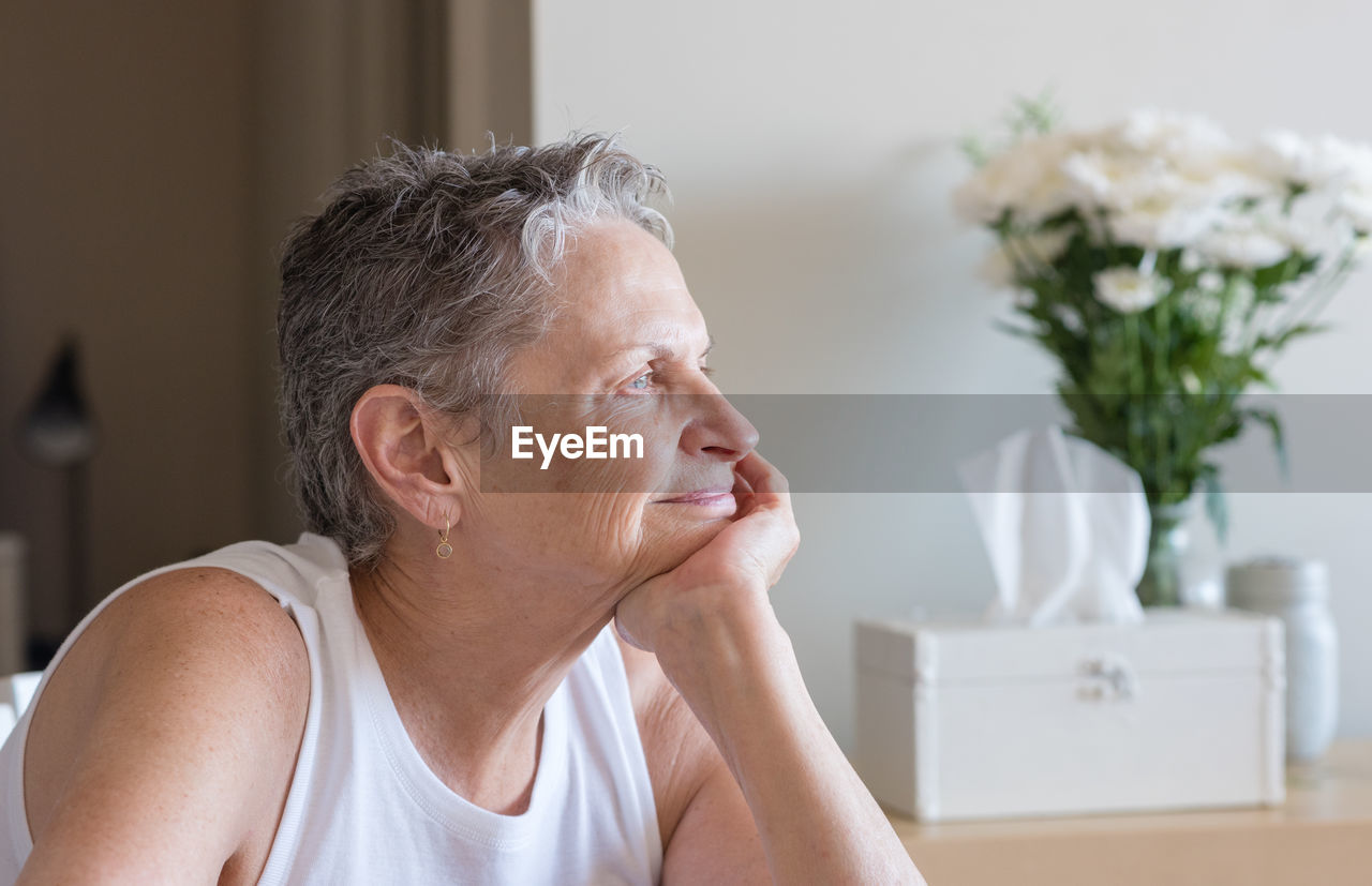 Close-up of senior woman sitting at home