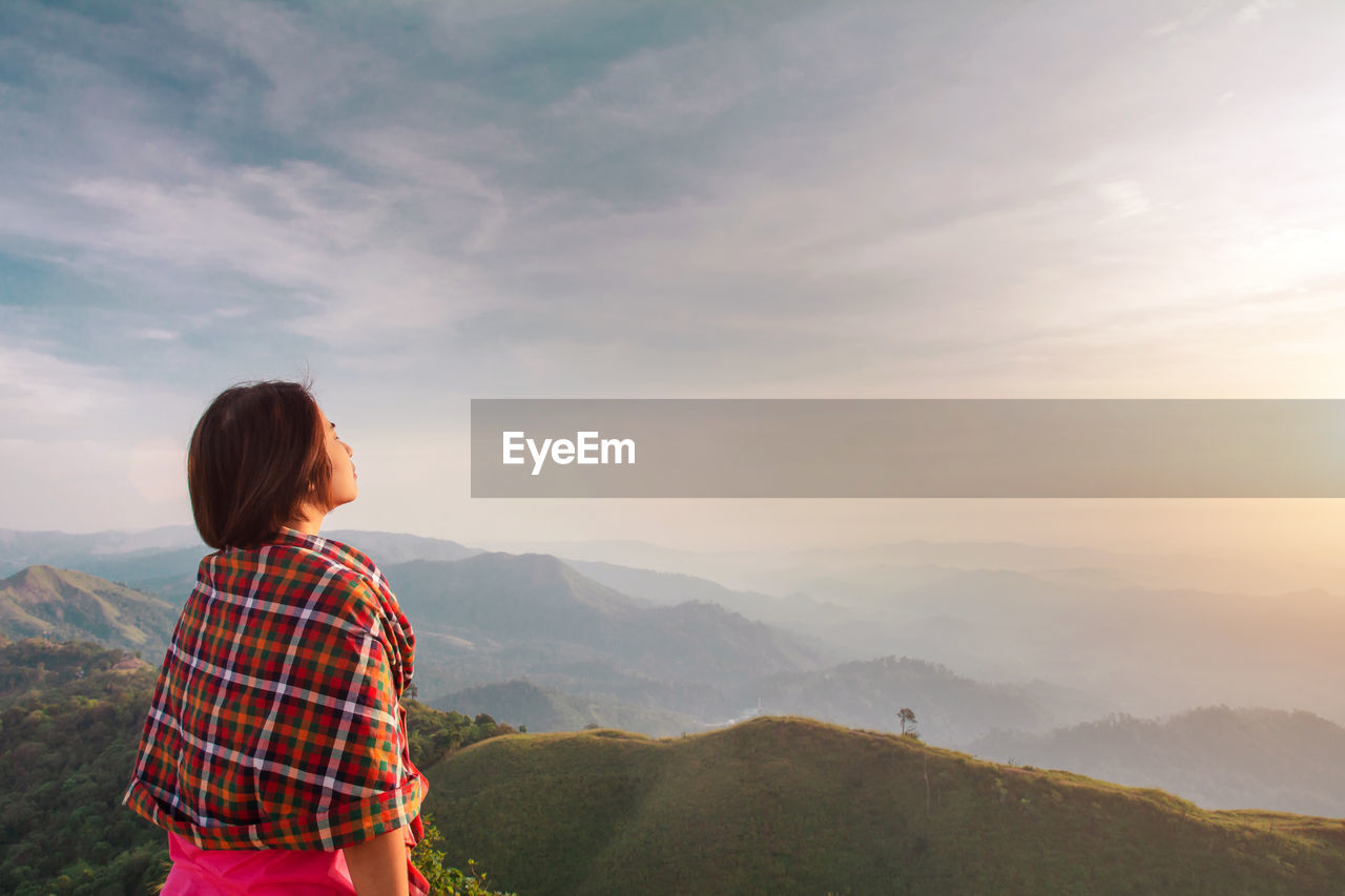 Woman against mountains and sky