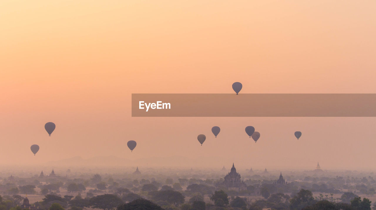 VIEW OF HOT AIR BALLOON AGAINST SKY AT SUNSET