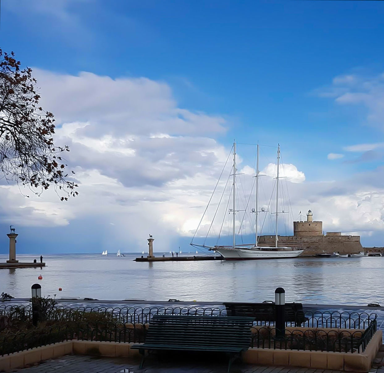 SAILBOATS IN HARBOR AGAINST SKY