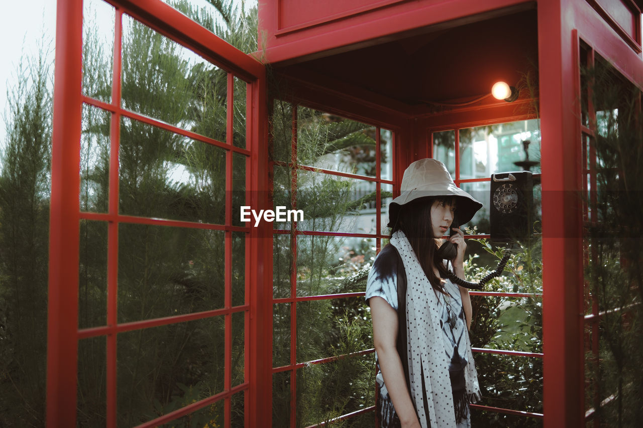 Woman using telephone booth