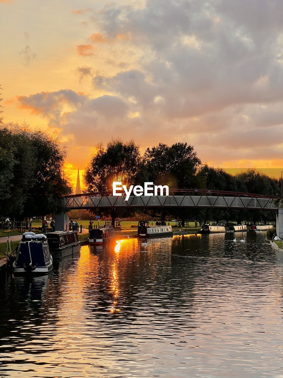 BRIDGE OVER RIVER DURING SUNSET