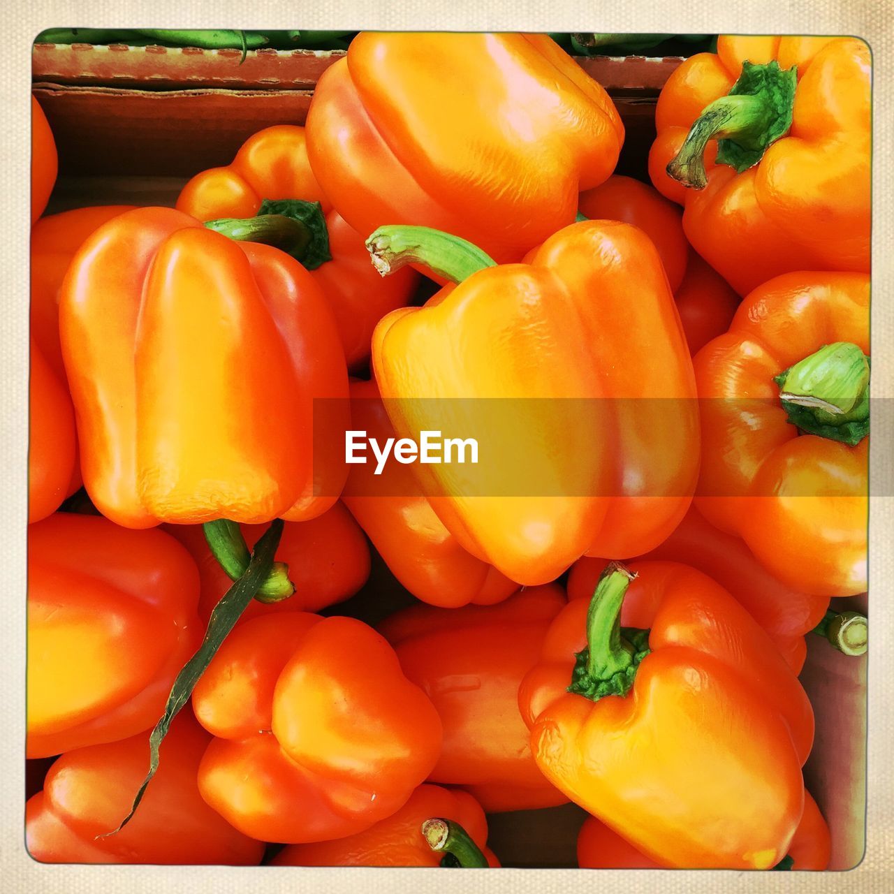 Full frame shot of orange bell peppers in box