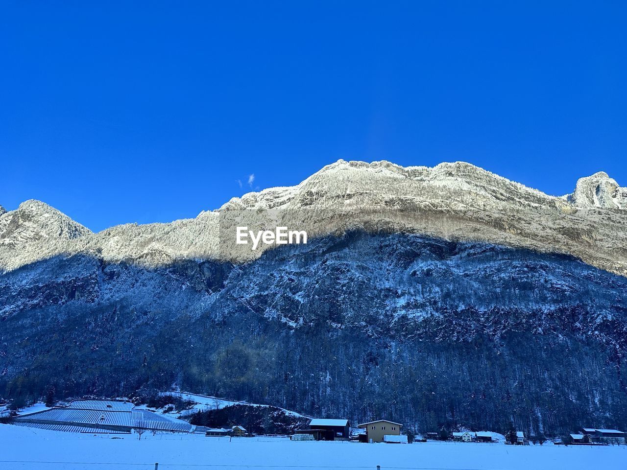 snow, mountain, cold temperature, winter, mountain range, scenics - nature, sky, beauty in nature, blue, environment, landscape, nature, clear sky, snowcapped mountain, no people, tranquil scene, tranquility, ridge, travel destinations, non-urban scene, plateau, day, travel, land, mountain peak, frozen, outdoors, summit, piste, idyllic, tree, sunny, tourism, coniferous tree, pinaceae, white, plant