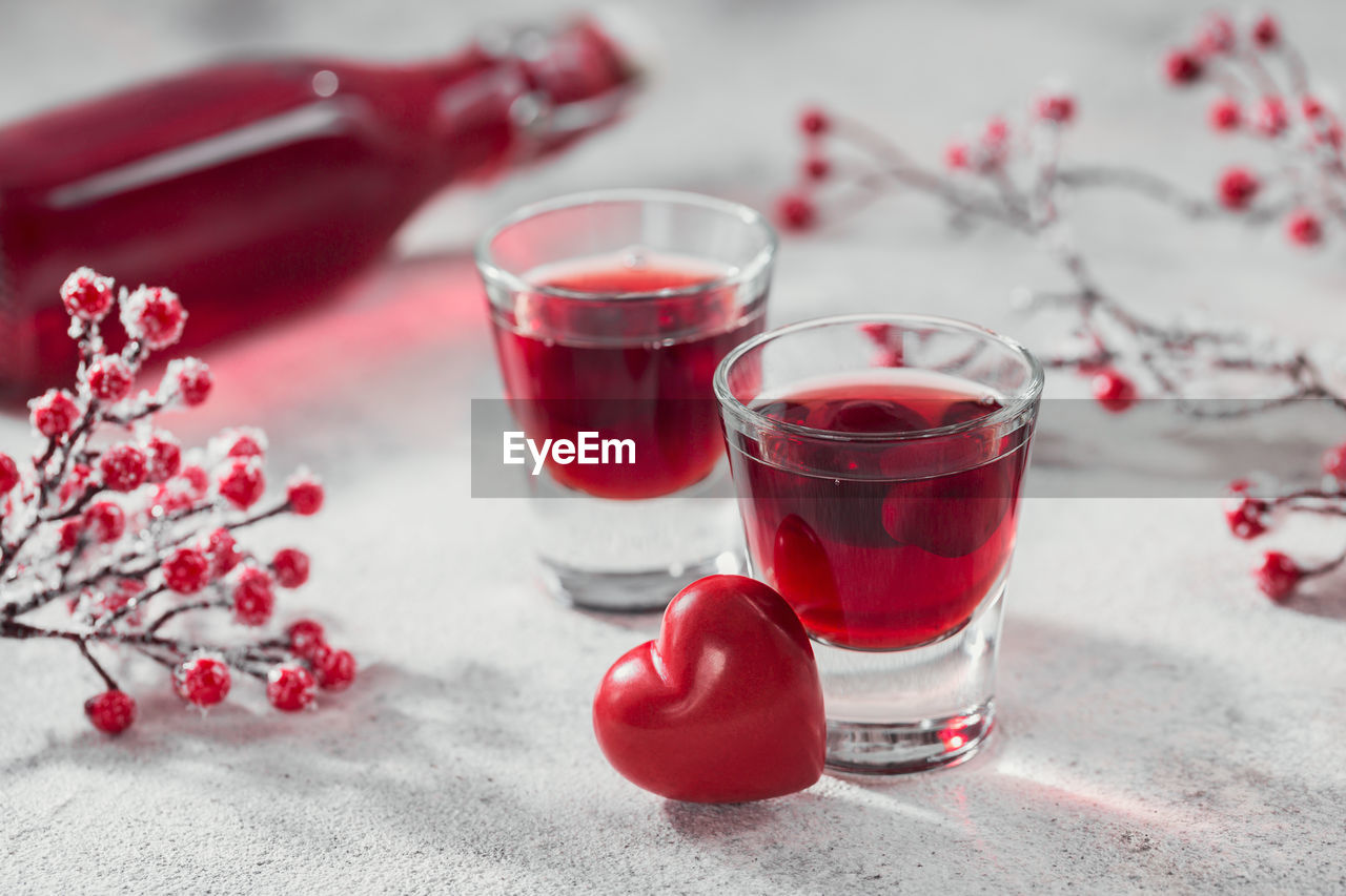 Red cocktail, vodka or liqueur and heart shape decorations