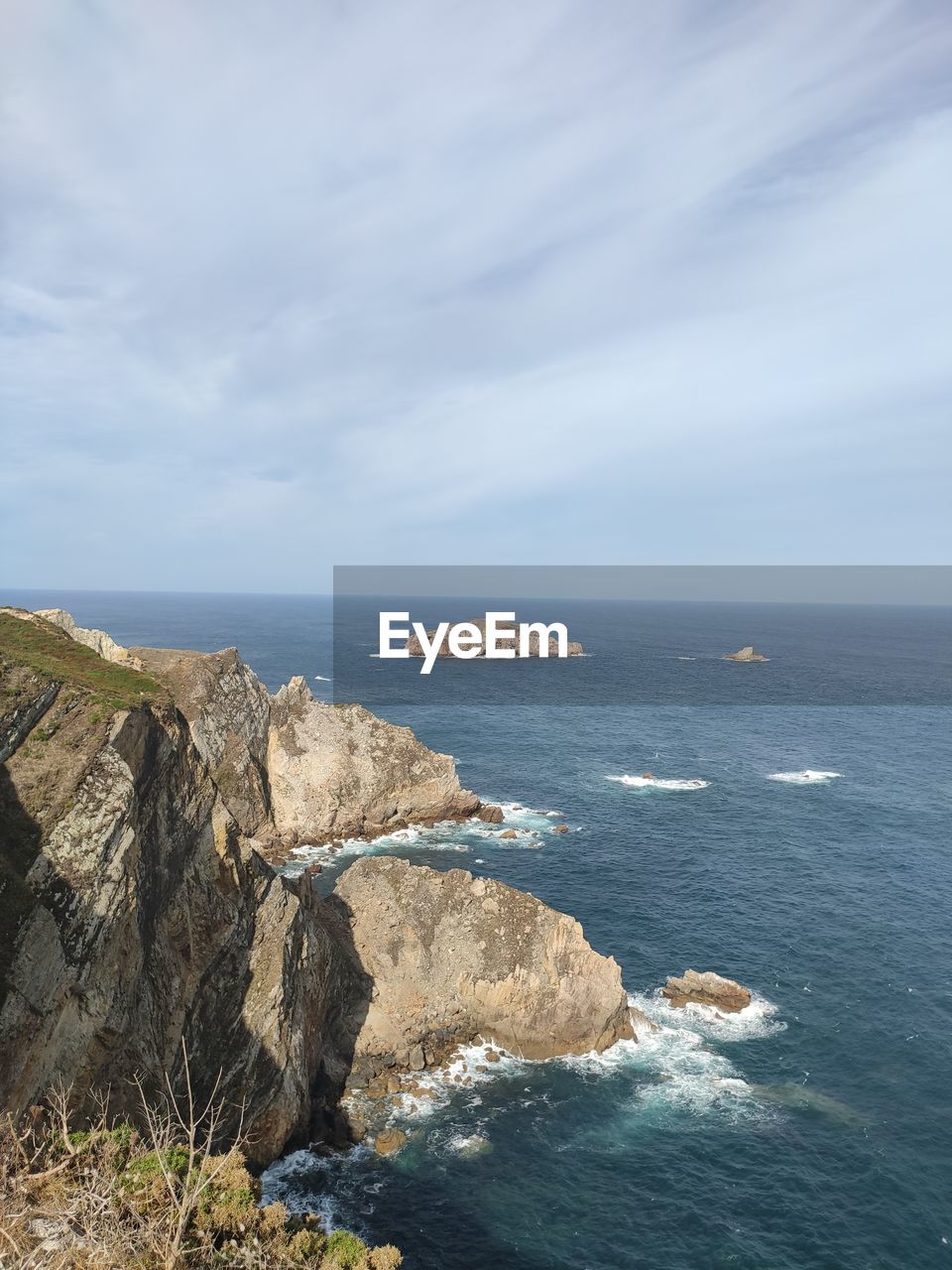 cliff, water, nature, sea, terrain, rock, day, sky, beauty in nature, scenics - nature, cloud, outdoors, mountain, no people, land, rock formation, sunlight, tranquility, coast, beach, panoramic, reflection, tranquil scene, blue, non-urban scene, environment, ocean, travel