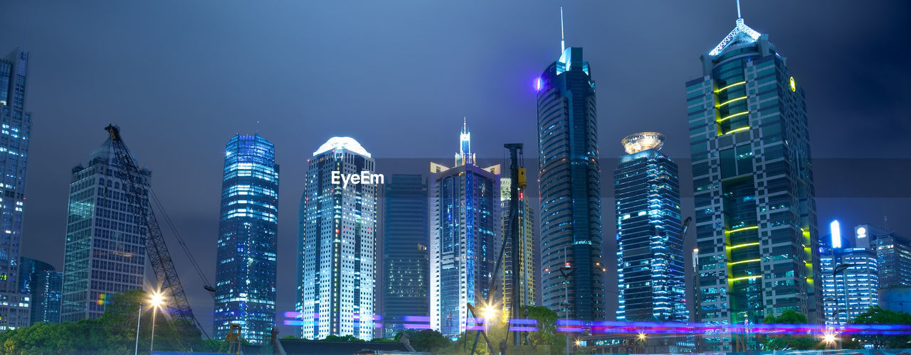 ILLUMINATED BUILDINGS AGAINST SKY AT NIGHT