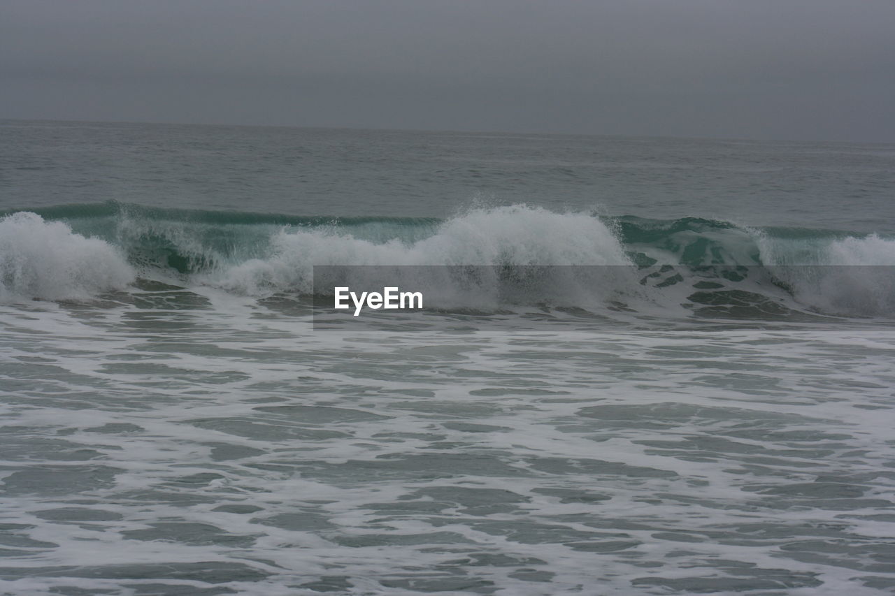 WAVES BREAKING AGAINST SEA