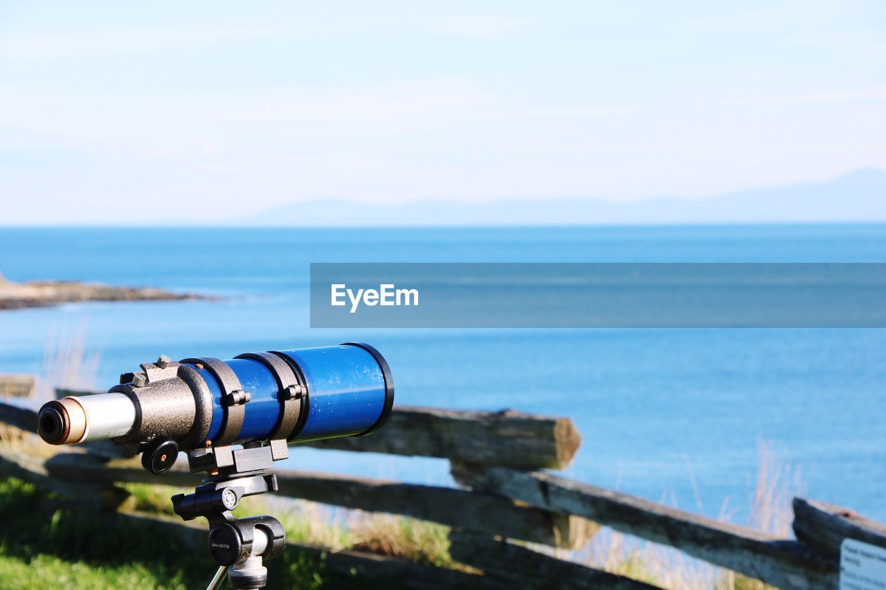 Close-up of camera on sea against sky