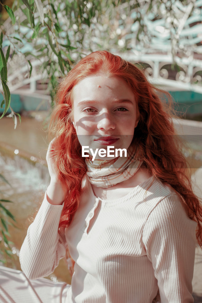 Portrait of smiling girl standing outdoors