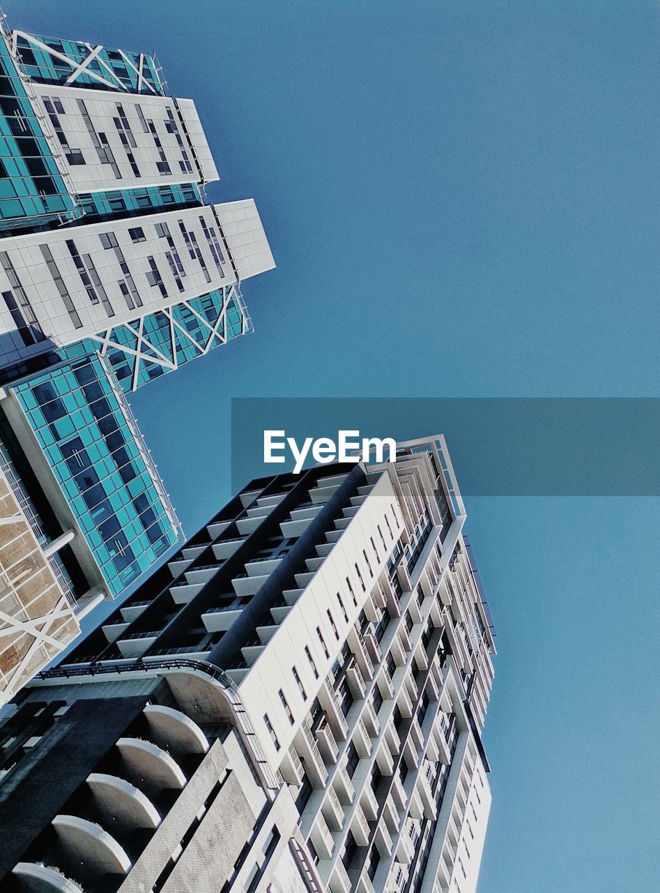 LOW ANGLE VIEW OF BUILDINGS AGAINST CLEAR SKY