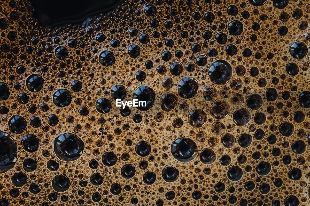 Macro shot of espresso foam. coffee background. close-up of bubbles