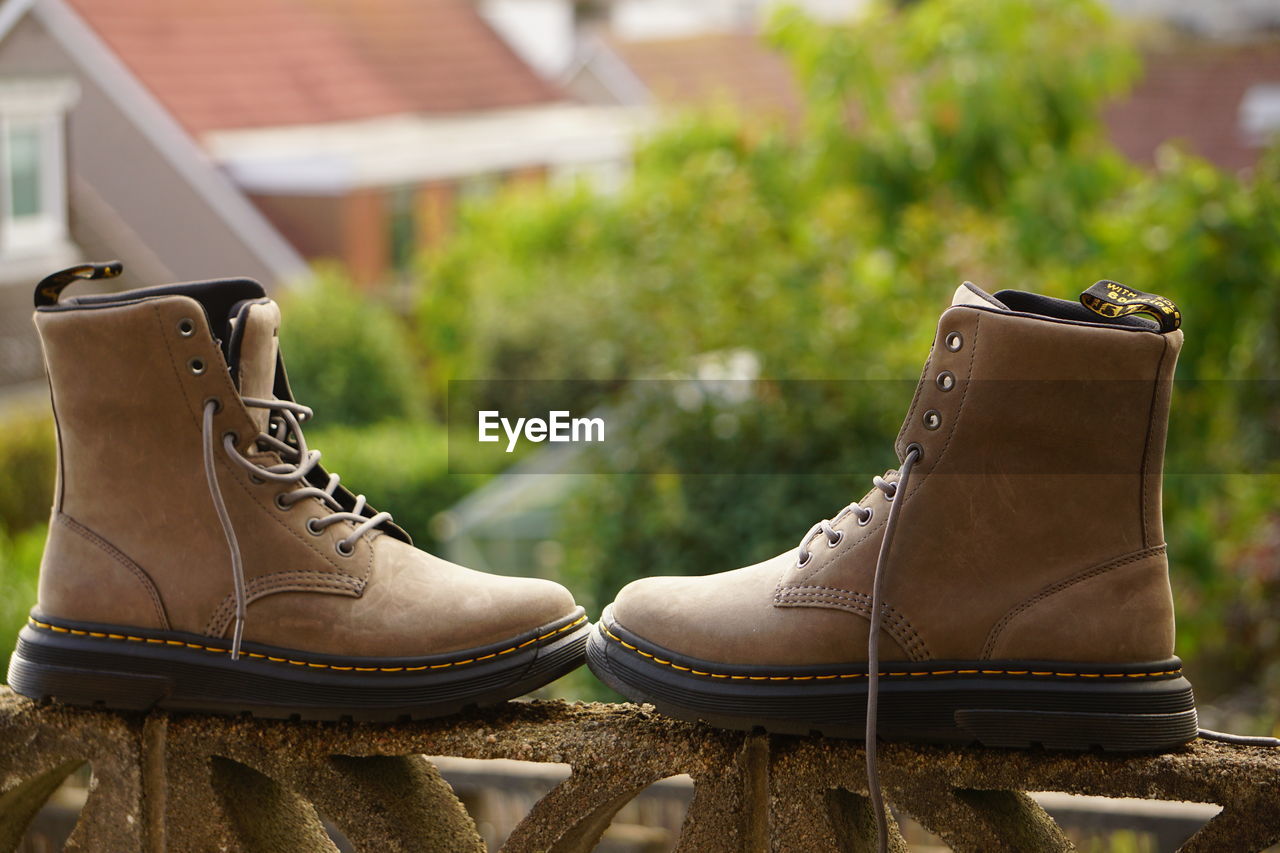 footwear, shoe, boot, brown, work boots, pair, spring, leather, focus on foreground, fashion, close-up, day, no people, outdoors, architecture, two objects, nature, motorcycle boot, snow boot, outdoor shoe, limb, plant, yellow