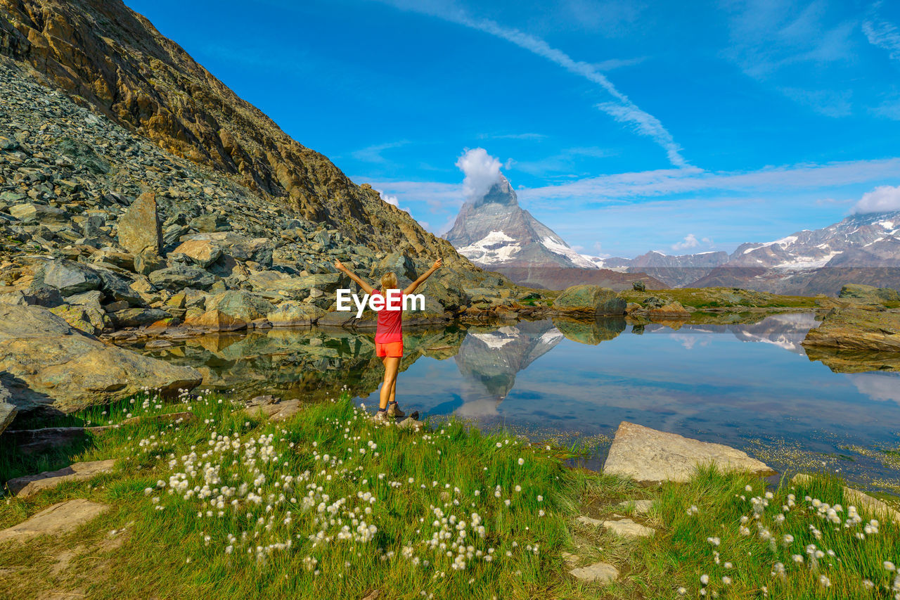 SCENIC VIEW OF LAKE AGAINST MOUNTAIN