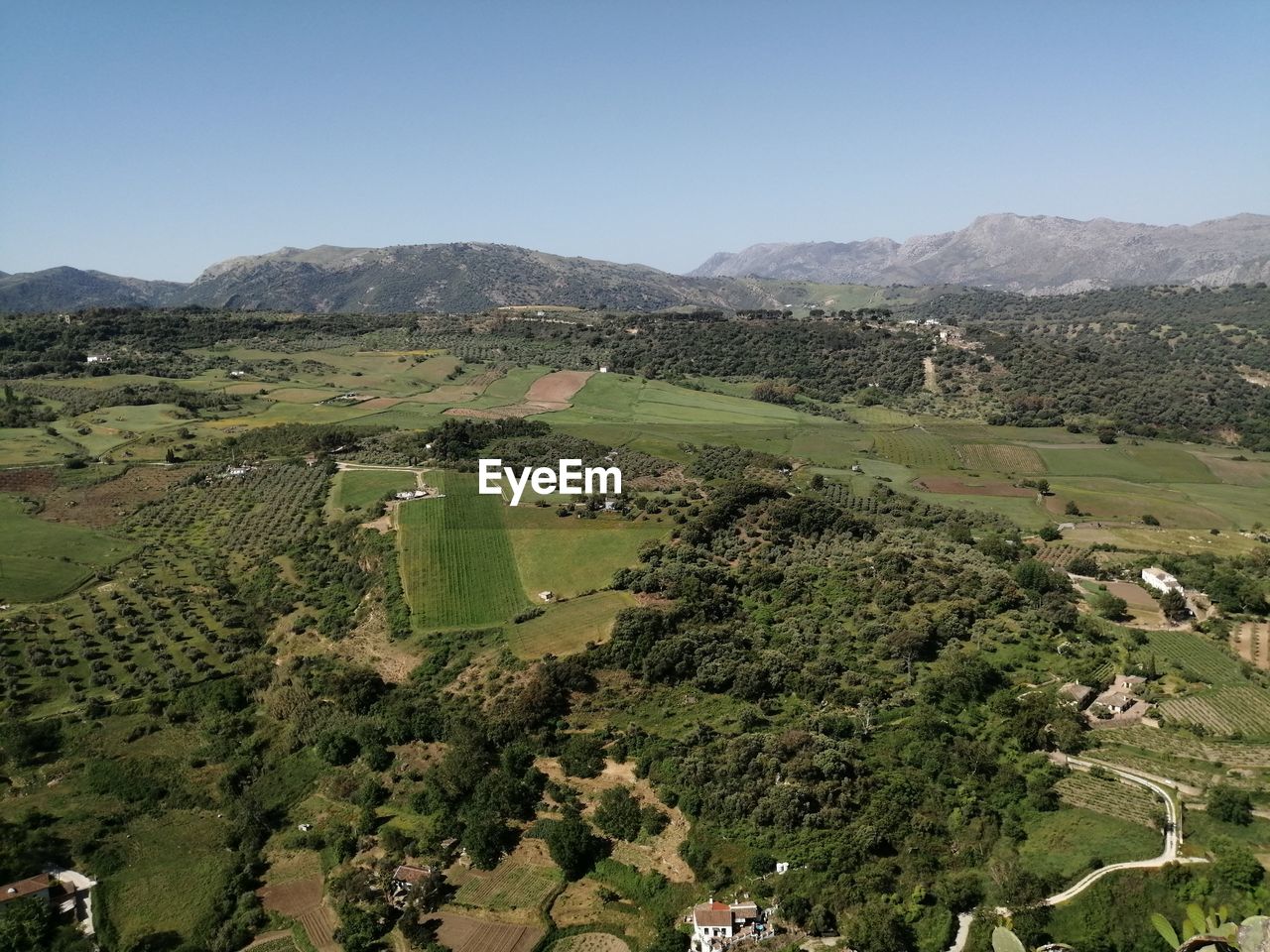 landscape, environment, scenics - nature, aerial photography, hill, plant, land, nature, sky, beauty in nature, tree, agriculture, village, rural area, rural scene, field, green, no people, tranquility, valley, bird's-eye view, mountain range, tranquil scene, non-urban scene, clear sky, outdoors, day, architecture, building, high angle view, sunny, blue, plateau, growth, travel, travel destinations, house, farm, plain, aerial view, tourism