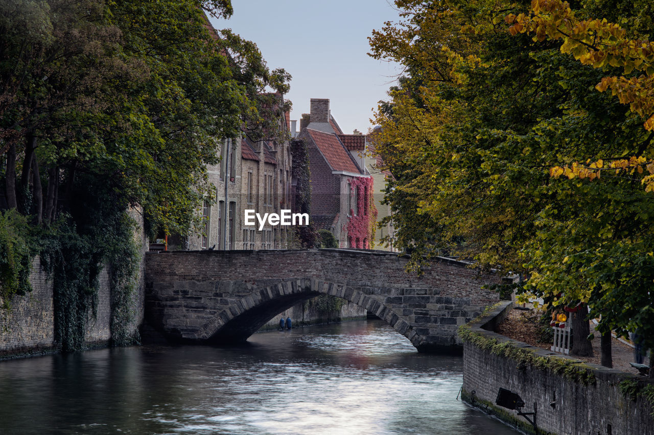 Bridge over river along built structures