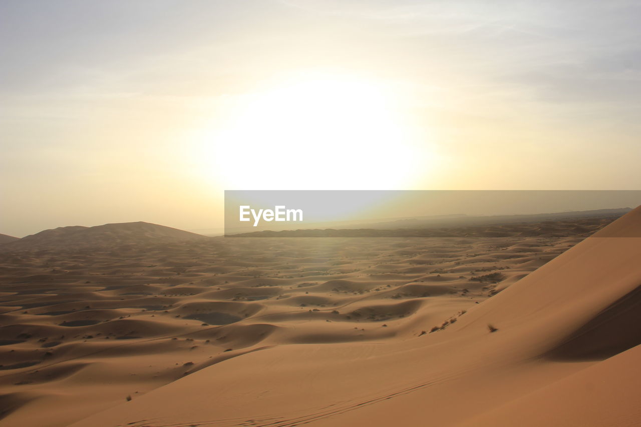 Scenic view of desert against sky during sunset