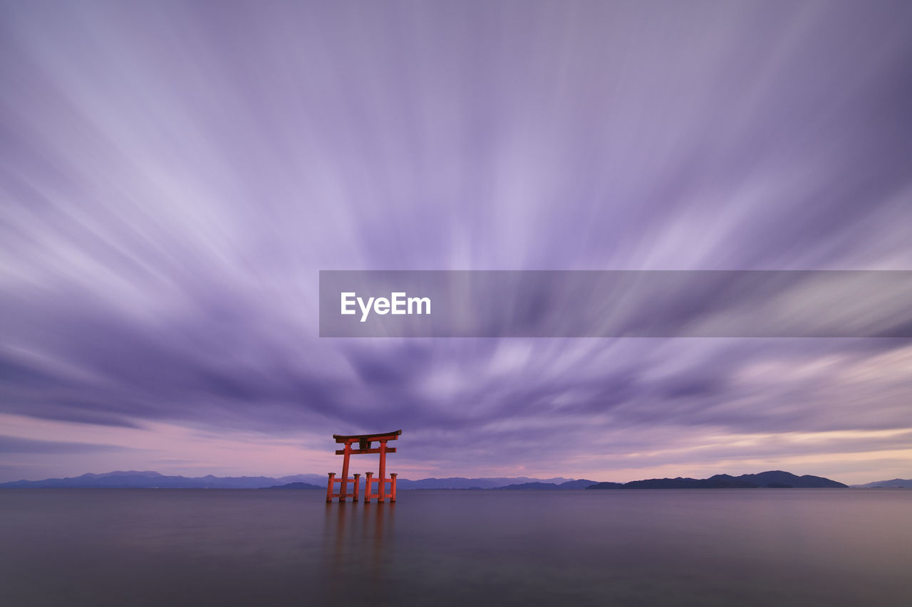 Long exposure shot of shirahige shrine torii gate at sunset at lake biwa, shiga prefecture, japan