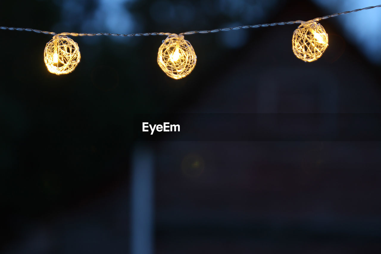 Close-up of illuminated lights outdoors at night