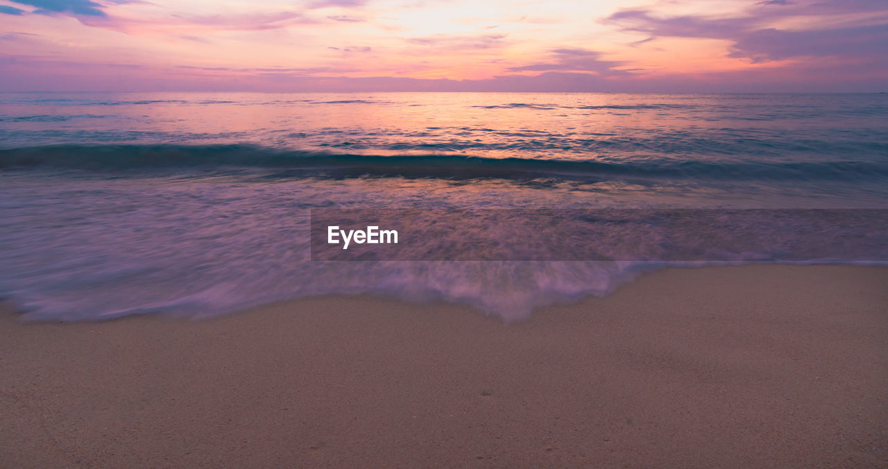 SCENIC VIEW OF BEACH DURING SUNSET