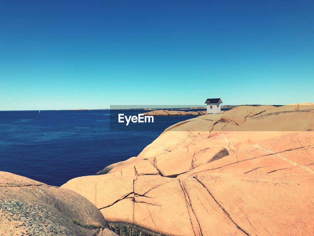 Scenic view of sea against clear blue sky