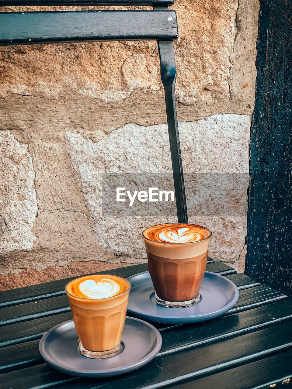 Close-up of coffee cup on table against wall