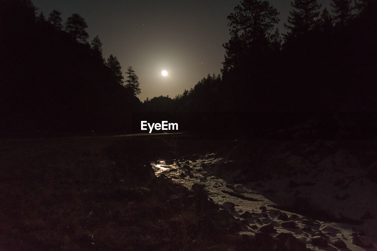 Scenic view of landscape against sky at night