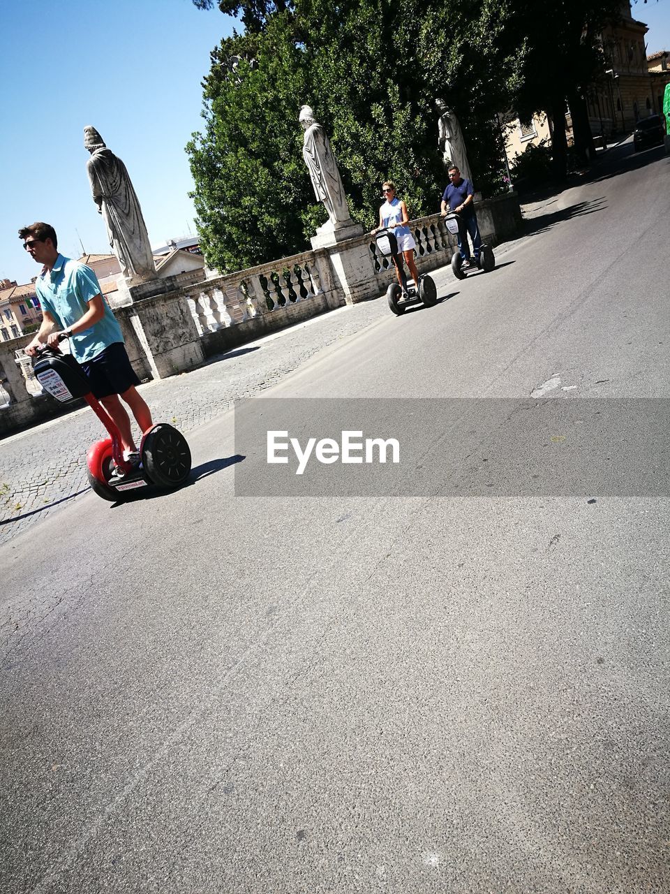 PEOPLE RIDING BICYCLE ON ROAD