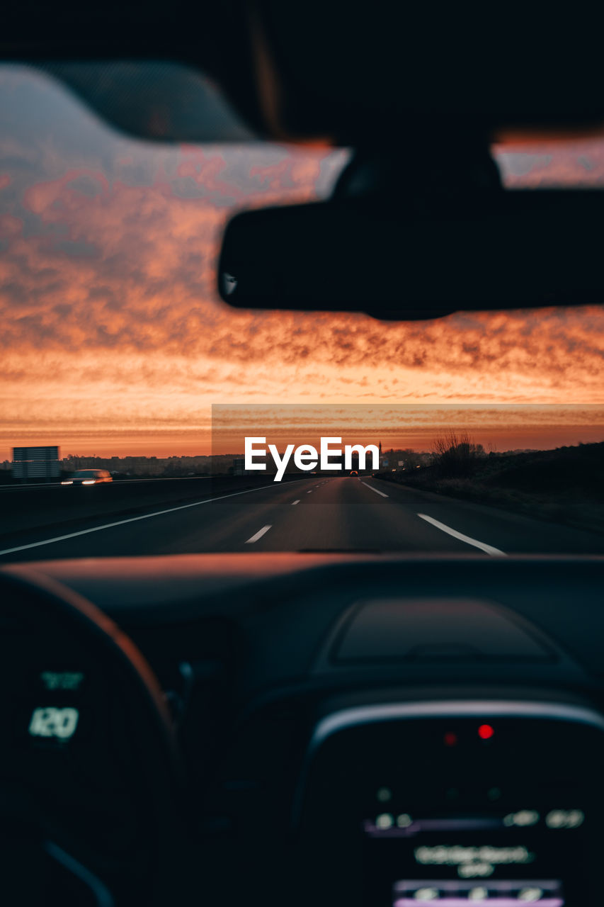 Car moving on road seen through windshield