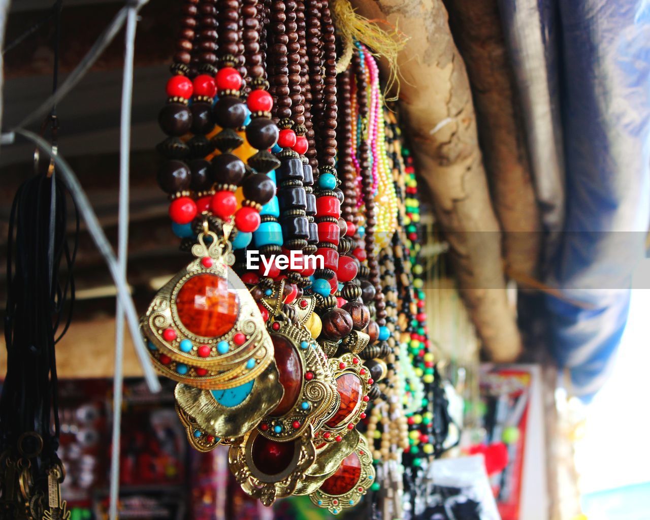 Close-up of necklaces hanging in store for sale