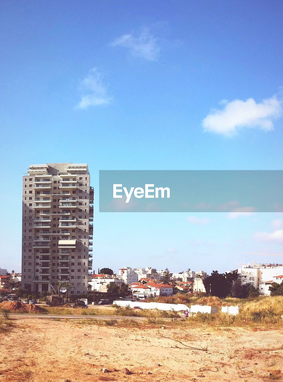 Distance shot of buildings against blue sky