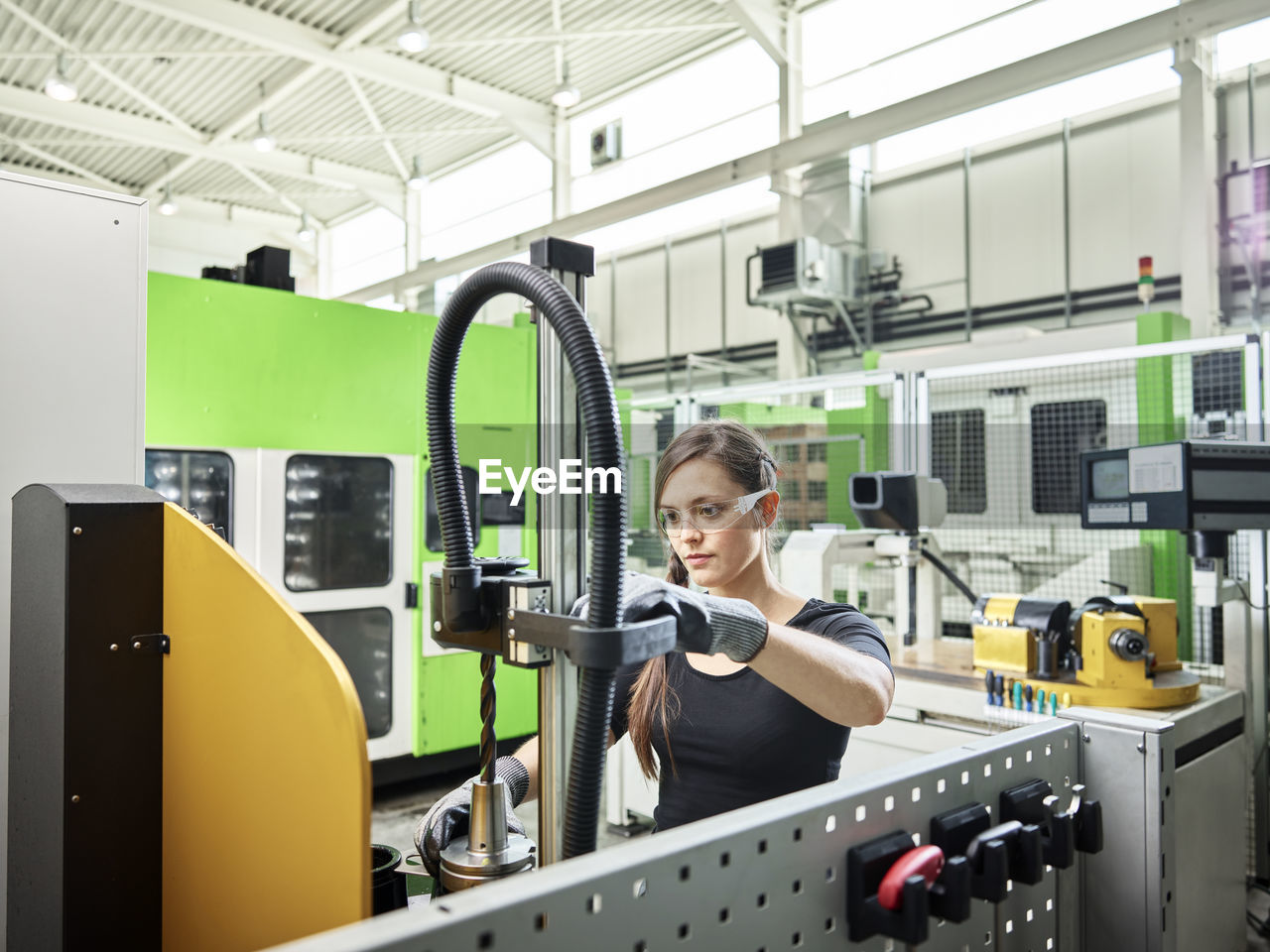 Young woman working on a machine