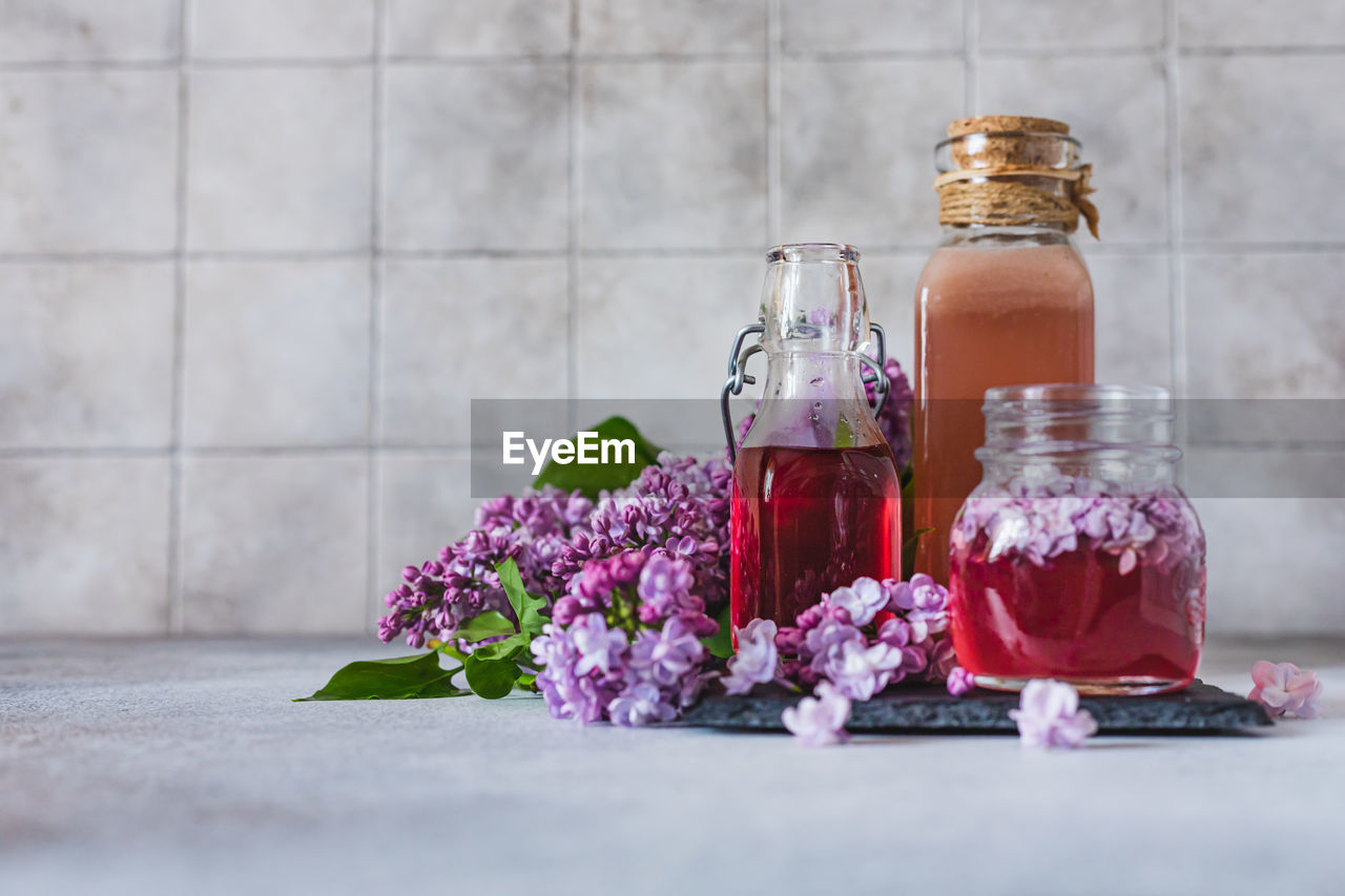 Preparation of syrup from the lilac flowers. glass jar of homemade lilac syrup 