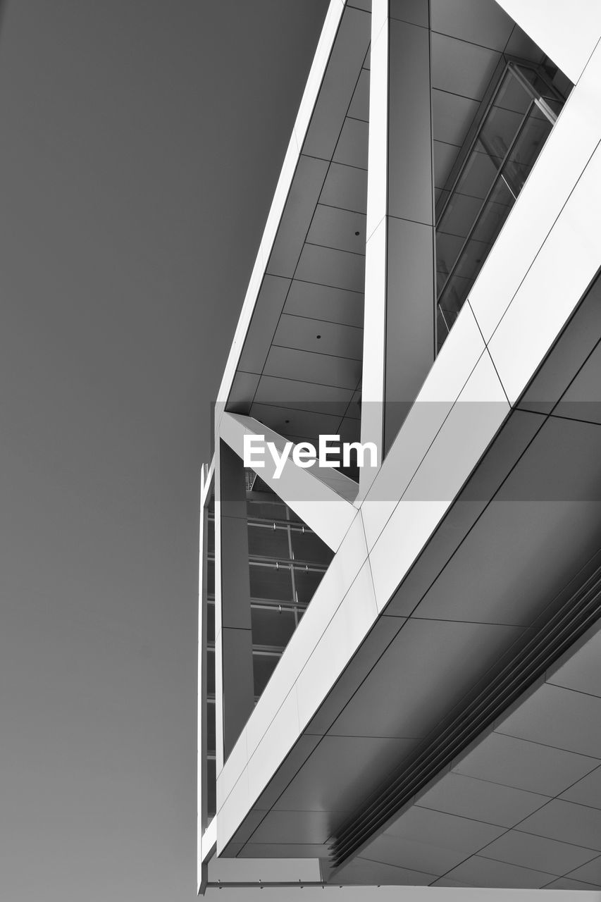 Low angle view of cropped built structures against clear sky