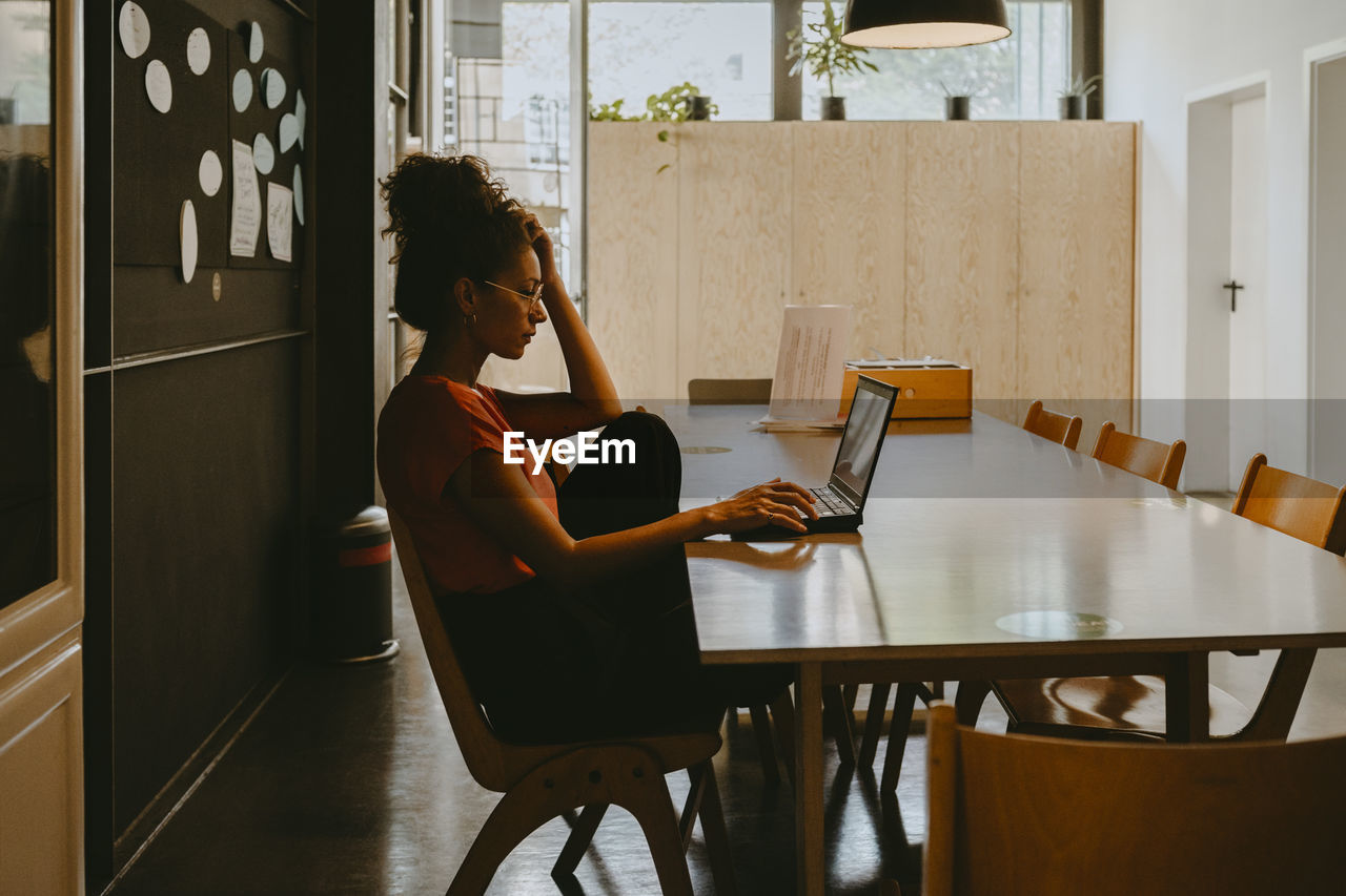 Female entrepreneur working on laptop in office