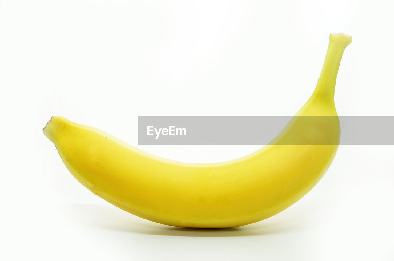 YELLOW FRUIT AGAINST WHITE BACKGROUND