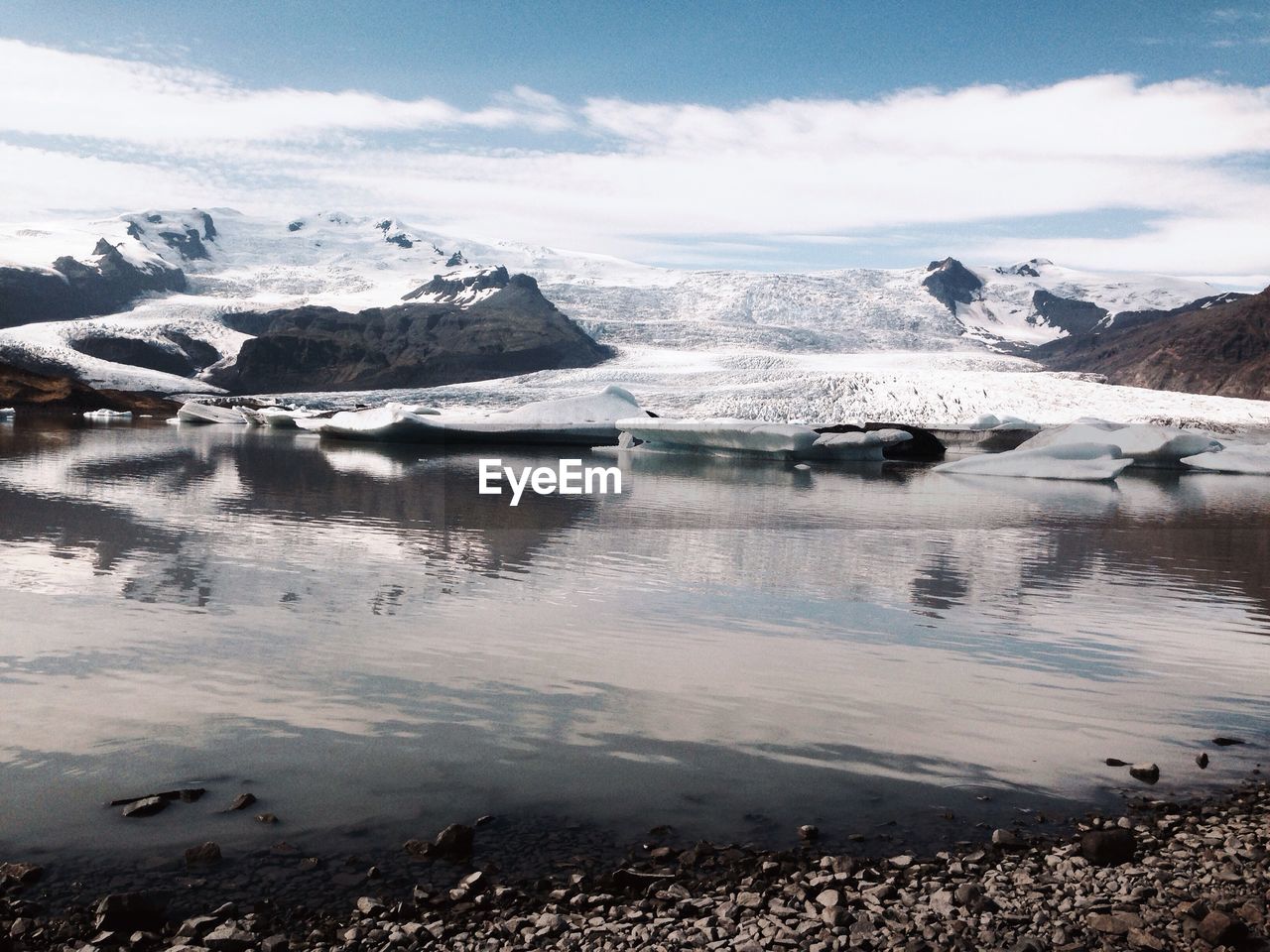 Beautiful scene of snow covered landscape by lake