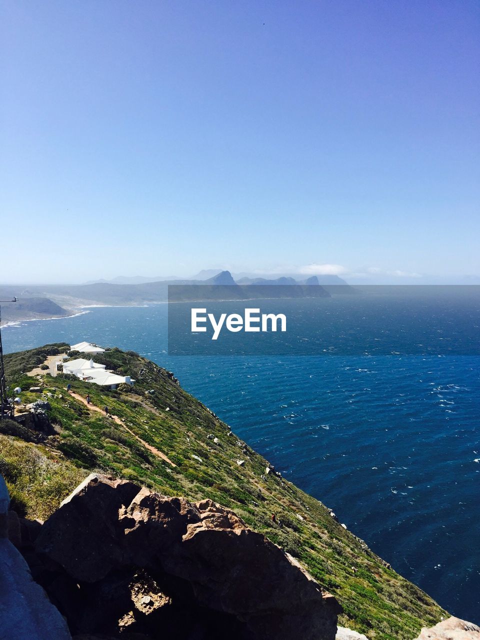 Scenic view of sea against clear blue sky